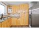 Bright kitchen featuring stainless steel refrigerator, updated cabinetry and modern countertops at 4946 Lake Ridge Trail, Lilburn, GA 30047