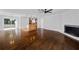 Spacious living room featuring gleaming hardwood floors and a cozy white stone fireplace at 4946 Lake Ridge Trail, Lilburn, GA 30047