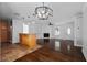 Open concept living space with hardwood floors, a kitchen island, and modern lighting fixtures at 4946 Lake Ridge Trail, Lilburn, GA 30047