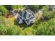 Aerial view of a stately home with a well-maintained backyard and a deck, nestled amidst lush greenery and mature trees at 530 Old Cobblestone Dr, Atlanta, GA 30350