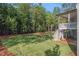 Expansive backyard featuring lush green lawn and a wooded perimeter, perfect for outdoor activities and privacy at 530 Old Cobblestone Dr, Atlanta, GA 30350