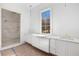 Bathroom showcasing double vanity with marble counters and a large glass-enclosed walk-in shower with dual shower heads at 530 Old Cobblestone Dr, Atlanta, GA 30350