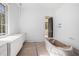 Bathroom featuring a vanity with dual sinks, marble countertops, and a free-standing tub still in protective wrapping at 530 Old Cobblestone Dr, Atlanta, GA 30350