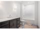 Bathroom with dark vanity, white quartz countertops, tile flooring, and shower-over-tub at 530 Old Cobblestone Dr, Atlanta, GA 30350