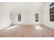 Bedroom featuring hardwood floors, white walls and trim, and lots of windows for natural light at 530 Old Cobblestone Dr, Atlanta, GA 30350