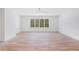 Large bedroom area with hardwood flooring, white walls and trim, ceiling fan, and many windows for natural light at 530 Old Cobblestone Dr, Atlanta, GA 30350