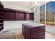 Dressing room complete with marble topped island, built-in shelving, hardwood flooring and window with outside view at 530 Old Cobblestone Dr, Atlanta, GA 30350