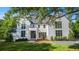 A bright, two-story home featuring a black roof and well-manicured lawn and landscaped grounds at 530 Old Cobblestone Dr, Atlanta, GA 30350