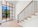 Bright foyer with a staircase featuring metal railings and wood accents at 530 Old Cobblestone Dr, Atlanta, GA 30350