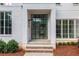 Modern front door with brick and stone steps leading up to the home's entrance at 530 Old Cobblestone Dr, Atlanta, GA 30350
