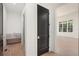 Hallway with hardwood floors leading to a bathroom and a bright living room at 530 Old Cobblestone Dr, Atlanta, GA 30350
