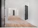 Hallway with light hardwood floors, white walls, and black doors with views to additional rooms at 530 Old Cobblestone Dr, Atlanta, GA 30350