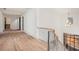 Upstairs hallway featuring hardwood floors, iron railing, and natural light at 530 Old Cobblestone Dr, Atlanta, GA 30350