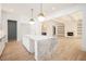 New kitchen featuring a marble island, brass hardware, and white cabinetry with an open concept at 530 Old Cobblestone Dr, Atlanta, GA 30350