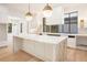 New kitchen featuring a marble island, brass hardware, and white cabinetry at 530 Old Cobblestone Dr, Atlanta, GA 30350