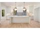 New kitchen featuring a marble island, brass hardware, and white cabinetry at 530 Old Cobblestone Dr, Atlanta, GA 30350