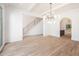 Bright living room featuring a staircase, modern lighting fixtures, and hardwood floors at 530 Old Cobblestone Dr, Atlanta, GA 30350