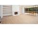 Bright living room featuring a fireplace, hardwood floors, and large windows to the outdoor deck at 530 Old Cobblestone Dr, Atlanta, GA 30350