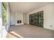 Outdoor patio with a brick fireplace, wood flooring, and enclosed by black trimmed windows at 530 Old Cobblestone Dr, Atlanta, GA 30350
