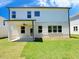 Backyard of a two-story home with a covered patio and lush green lawn at 62 Sheryl Way, Loganville, GA 30052