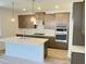 Modern kitchen features stainless steel appliances, stylish cabinets, a large island with quartz countertop at 62 Sheryl Way, Loganville, GA 30052