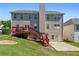 Two-story home with deck, stairs, and patio with grass backyard at 829 Castlebottom Dr, Lawrenceville, GA 30045