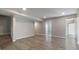 Partially finished basement with wood-look flooring, neutral walls, and access to stairs and additional rooms at 829 Castlebottom Dr, Lawrenceville, GA 30045