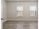 Bright bedroom with two windows, white trim and wood-look flooring at 829 Castlebottom Dr, Lawrenceville, GA 30045