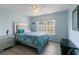Stylish bedroom with modern decor, comfortable bed, wood-look floors, and natural light streaming in from the large window at 829 Castlebottom Dr, Lawrenceville, GA 30045