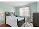 A bedroom with hardwood floors, a large window, and a queen-size bed at 829 Castlebottom Dr, Lawrenceville, GA 30045