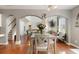 A dining room with hardwood floors, gray walls, and arched doorways to the living room at 829 Castlebottom Dr, Lawrenceville, GA 30045