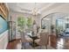 Bright dining room with stylish decor, including a glass table, upholstered chairs, and large window at 829 Castlebottom Dr, Lawrenceville, GA 30045