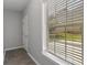 Hallway with wood-look floors and a large window looking out onto the lawn at 829 Castlebottom Dr, Lawrenceville, GA 30045