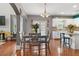 Open kitchen area with a dining table and bar stool seating, offering a modern and inviting space at 829 Castlebottom Dr, Lawrenceville, GA 30045