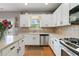 This traditional kitchen features white cabinets, stainless steel appliances and light countertops at 829 Castlebottom Dr, Lawrenceville, GA 30045