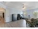 Spacious primary bedroom featuring a tray ceiling, hardwood floors, sitting area, and television at 829 Castlebottom Dr, Lawrenceville, GA 30045