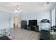 Spacious primary bedroom featuring a tray ceiling, hardwood floors, sitting area, and a treadmill at 829 Castlebottom Dr, Lawrenceville, GA 30045