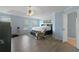 Spacious primary bedroom featuring tray ceiling, hardwood floors, ensuite bath, and sitting area at 829 Castlebottom Dr, Lawrenceville, GA 30045