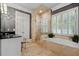 Elegant bathroom featuring a glass enclosed shower and a soaking tub at 1070 Standard Ne Dr, Brookhaven, GA 30319