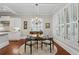 Dining room featuring a chandelier, round glass table, shuttered windows, and white trim at 1070 Standard Ne Dr, Brookhaven, GA 30319