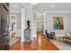 Inviting foyer with rich hardwood floors, elegant trim, and views into the kitchen and living spaces with an art collection at 1070 Standard Ne Dr, Brookhaven, GA 30319