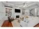 Stylish living room with a fireplace, built-in bookshelves, ceiling fan, and comfortable seating at 1070 Standard Ne Dr, Brookhaven, GA 30319