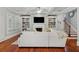 Bright living room featuring hardwood floors, a fireplace, built-in bookshelves, and access to the staircase at 1070 Standard Ne Dr, Brookhaven, GA 30319
