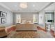 Well-lit main bedroom with a tufted headboard, chandelier, and doorway to an office at 1070 Standard Ne Dr, Brookhaven, GA 30319