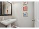 Powder room featuring a pedestal sink, framed mirror, and neutral wall paint at 1070 Standard Ne Dr, Brookhaven, GA 30319