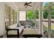 Relaxing screened porch with comfortable seating, ceiling fan, and views of the backyard at 1070 Standard Ne Dr, Brookhaven, GA 30319