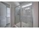 Bathroom shower with glass doors, gray tile, a built-in bench, and a bright window at 158 Bryon Ln, Acworth, GA 30102