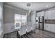 Dining area with modern decor, a glass table, white chairs, and stainless steel refrigerator at 158 Bryon Ln, Acworth, GA 30102