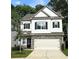 Charming two-story home features white siding, stone accents, a two-car garage, and a manicured lawn at 158 Bryon Ln, Acworth, GA 30102