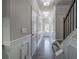 Inviting hallway with wood-look floors, decorative wainscoting, and modern lighting fixtures leading to the staircase at 158 Bryon Ln, Acworth, GA 30102